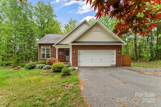 view of front of house featuring an attached garage, aphalt driveway, a front lawn, and brick siding
