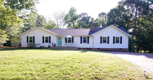 ranch-style home featuring a chimney, a front lawn, driveway, and crawl space