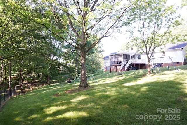 854 Silver Fox Dr, Concord, NC 28025 - view of green lawn with a sunroom, stairs, a wooden deck, and a playground