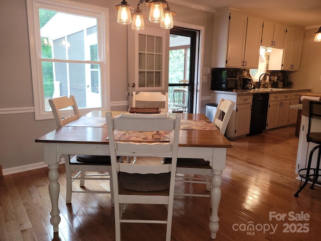 854 Silver Fox Dr, Concord, NC 28025 - dining space with plenty of natural light, light wood finished floors, baseboards, and crown molding