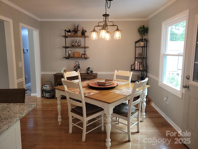 854 Silver Fox Dr, Concord, NC 28025 - dining area with light wood-style flooring, crown molding, a chandelier, and baseboards