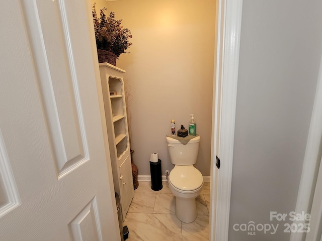 854 Silver Fox Dr, Concord, NC 28025 - bathroom featuring marble look tile flooring and toilet