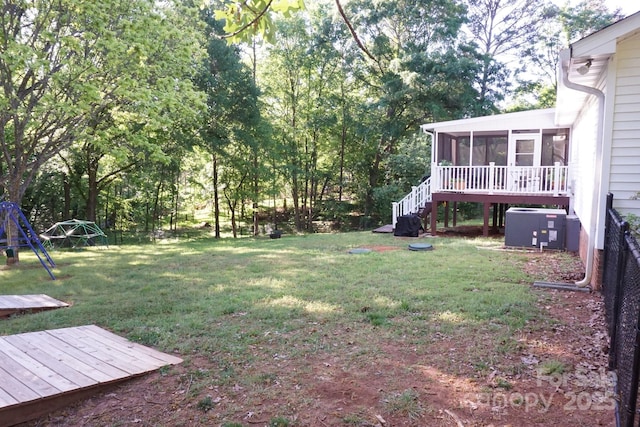 854 Silver Fox Dr, Concord, NC 28025 - view of green lawn with a sunroom, stairs, a wooden deck, and a playground