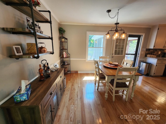 854 Silver Fox Dr, Concord, NC 28025 - dining area featuring healthy amount of natural light, light wood finished floors, and crown molding