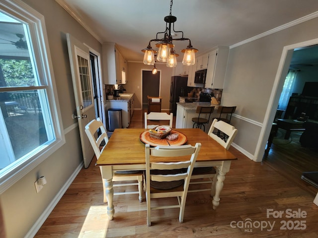 854 Silver Fox Dr, Concord, NC 28025 - dining area with plenty of natural light, wood finished floors, and crown molding