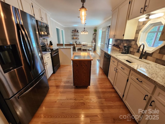854 Silver Fox Dr, Concord, NC 28025 - kitchen featuring black appliances, light wood-type flooring, healthy amount of natural light, tasteful backsplash, and ornamental molding