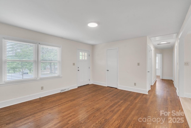 entrance foyer featuring baseboards, visible vents, and wood finished floors