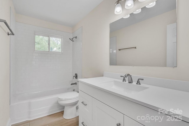 full bath with toilet, shower / washtub combination, wood finished floors, and vanity