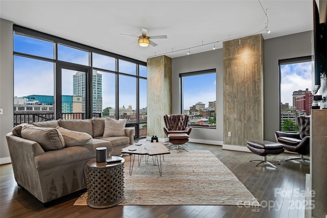 living room featuring a view of city, ceiling fan, dark wood finished floors, and track lighting