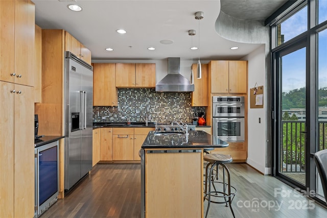 kitchen featuring wall chimney exhaust hood, wine cooler, dark wood finished floors, and stainless steel appliances
