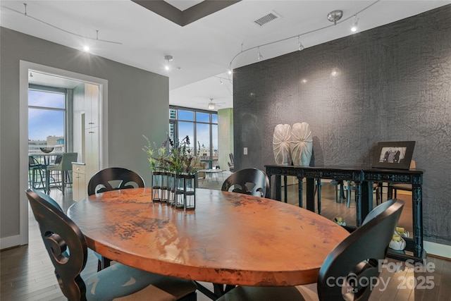 dining area with baseboards, a ceiling fan, hardwood / wood-style flooring, and visible vents