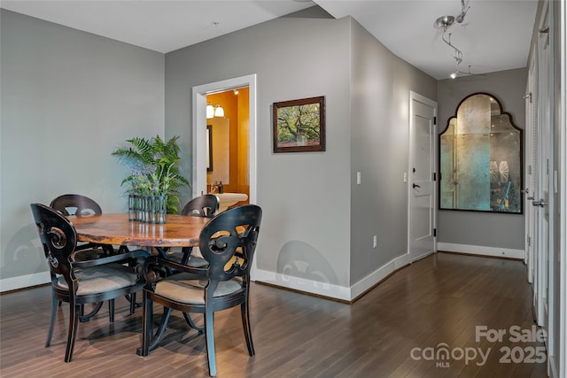 dining area with baseboards and wood finished floors
