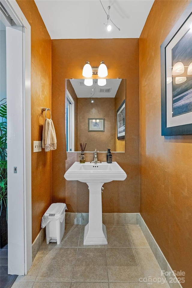 bathroom featuring tile patterned floors, baseboards, and visible vents