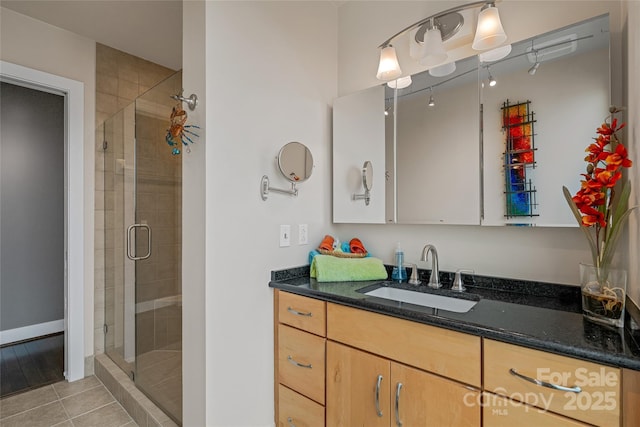 bathroom featuring vanity, tile patterned floors, and a shower stall