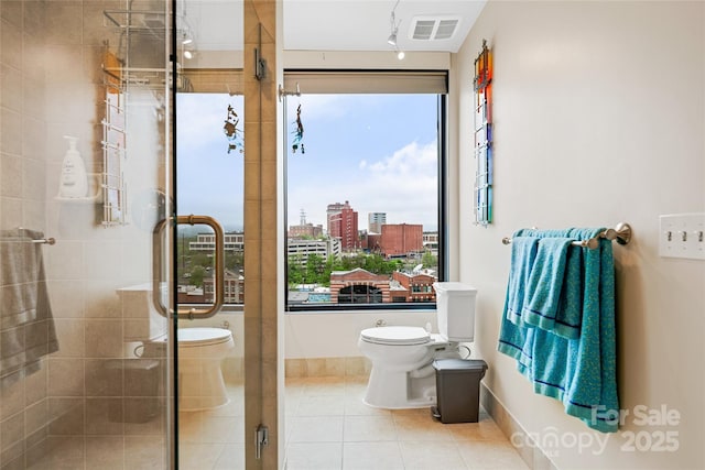 full bath with visible vents, tile patterned flooring, toilet, baseboards, and a shower stall