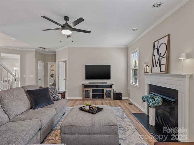 3 Holmes Ln, Arden, NC 28704 - living area featuring a ceiling fan, a fireplace, stairway, and light wood finished floors
