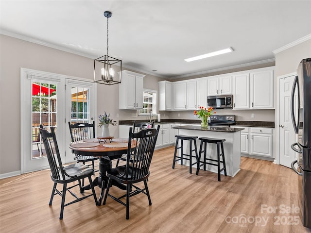 3 Holmes Ln, Arden, NC 28704 - dining space featuring an inviting chandelier, crown molding, and light wood-style flooring