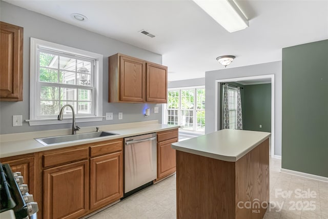 kitchen featuring visible vents, a sink, brown cabinets, light countertops, and appliances with stainless steel finishes