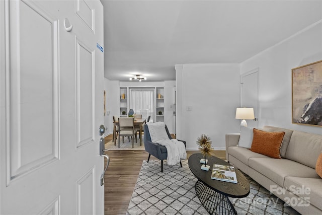 living room featuring baseboards and wood finished floors
