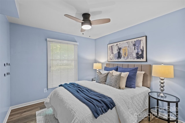 bedroom featuring baseboards, a ceiling fan, and wood finished floors