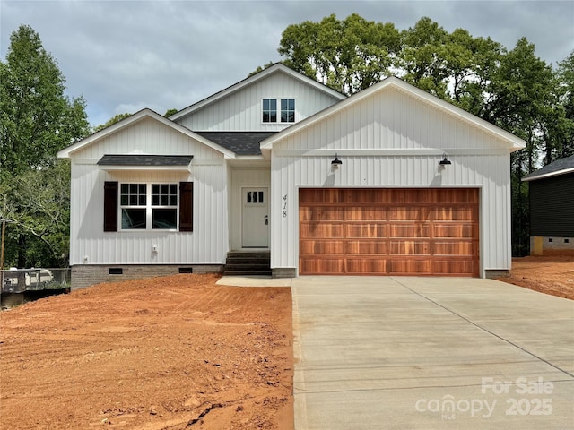 modern farmhouse with driveway, crawl space, an attached garage, and roof with shingles