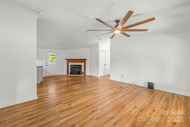 1005 Caldon Dr, Stanley, NC 28164 - unfurnished living room with ceiling fan, light wood-style flooring, and a tile fireplace