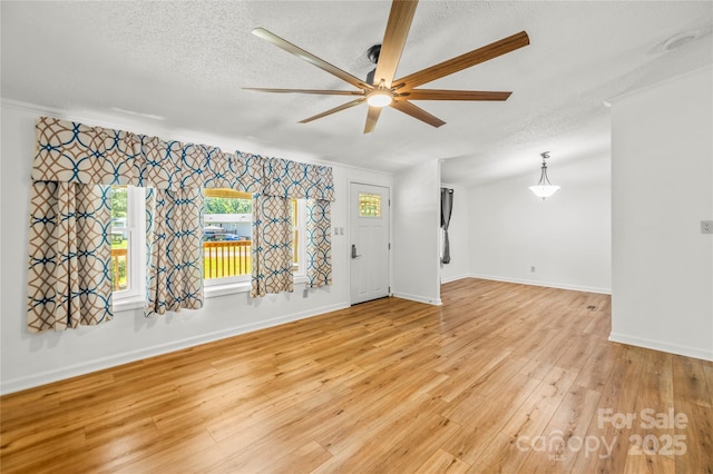 1005 Caldon Dr, Stanley, NC 28164 - empty room featuring a ceiling fan, a textured ceiling, light wood finished floors, and ornamental molding