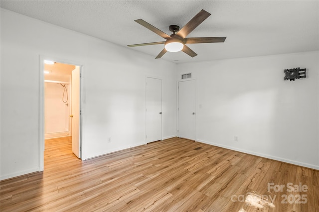 1005 Caldon Dr, Stanley, NC 28164 - unfurnished bedroom with light wood-type flooring, connected bathroom, and ceiling fan