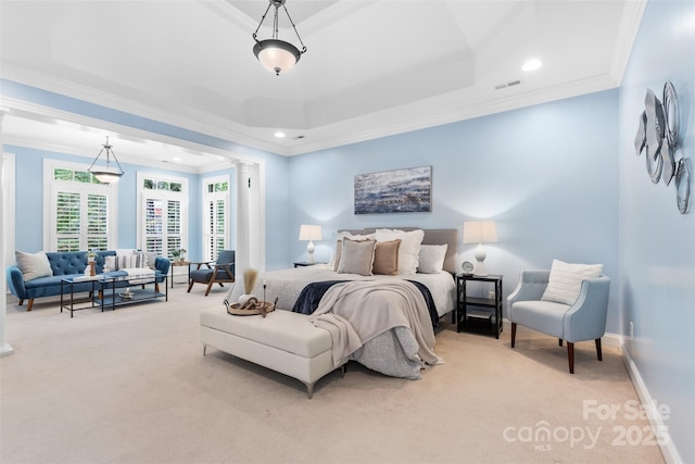 bedroom with carpet floors, ornamental molding, visible vents, and a raised ceiling