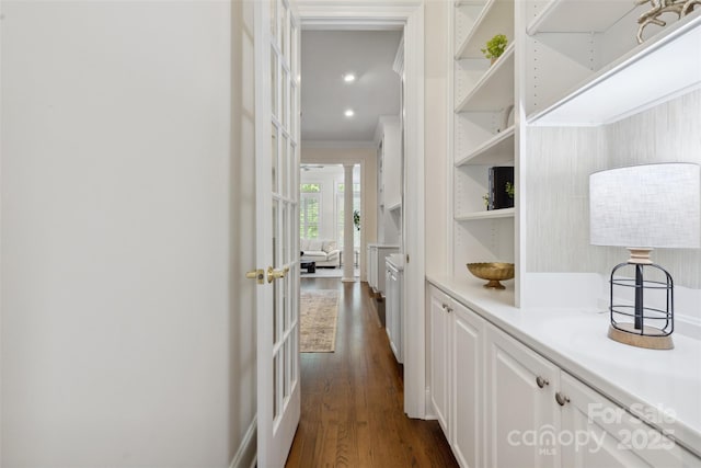 hall with crown molding, dark wood finished floors, and french doors