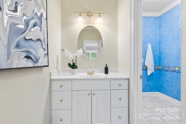 bathroom featuring crown molding, vanity, marble finish floor, wallpapered walls, and baseboards