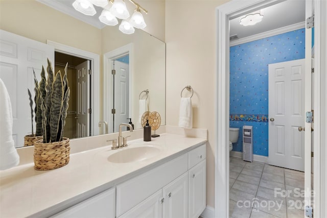 bathroom with an inviting chandelier, vanity, toilet, tile patterned floors, and wallpapered walls