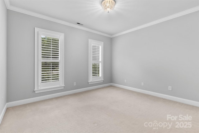 carpeted empty room with crown molding, baseboards, and visible vents
