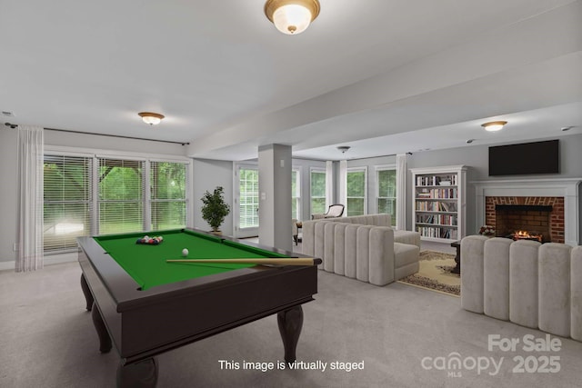 rec room featuring a brick fireplace, pool table, light carpet, and plenty of natural light