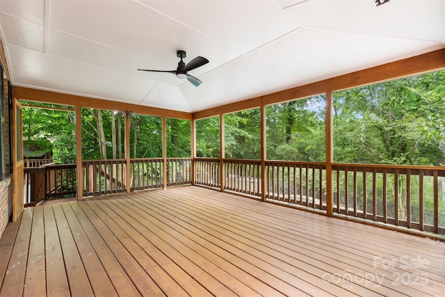 unfurnished sunroom featuring a ceiling fan