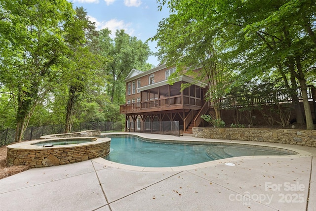 outdoor pool featuring an in ground hot tub, a patio area, a sunroom, a fenced backyard, and stairs