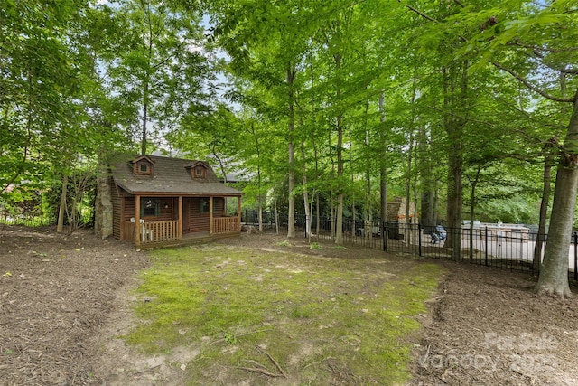 view of yard featuring fence and an outdoor structure