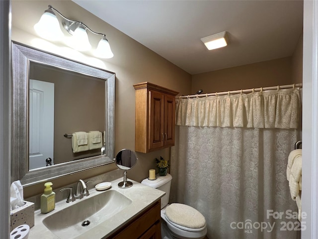 full bath featuring toilet, a shower with shower curtain, and vanity