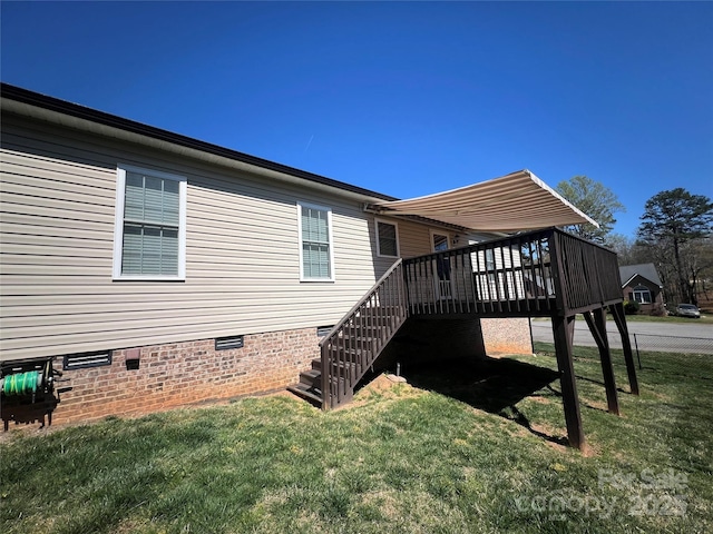 exterior space featuring a wooden deck, stairs, a yard, and crawl space