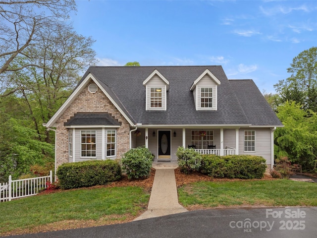 103 Higgins Rd, Fletcher, NC 28732 - new england style home with covered porch, roof with shingles, fence, and a front yard
