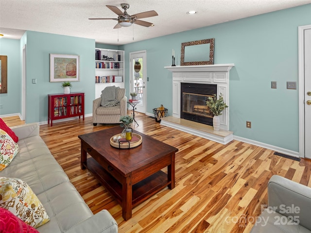 103 Higgins Rd, Fletcher, NC 28732 - living area with light wood-style floors, a ceiling fan, and a textured ceiling