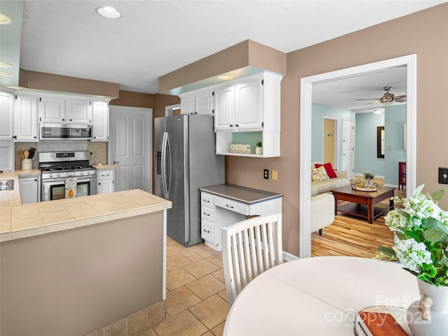 103 Higgins Rd, Fletcher, NC 28732 - kitchen featuring recessed lighting, backsplash, a ceiling fan, white cabinets, and appliances with stainless steel finishes