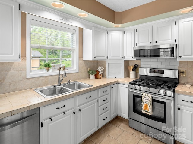 103 Higgins Rd, Fletcher, NC 28732 - kitchen with white cabinets, stainless steel appliances, tasteful backsplash, and a sink