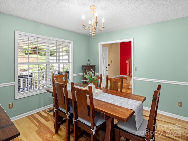 103 Higgins Rd, Fletcher, NC 28732 - dining room with baseboards, an inviting chandelier, light wood-type flooring, and a textured ceiling