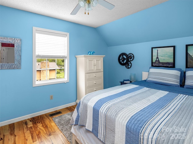 103 Higgins Rd, Fletcher, NC 28732 - bedroom with a ceiling fan, vaulted ceiling, baseboards, visible vents, and wood finished floors