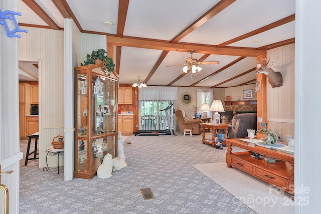 carpeted living room featuring a fireplace, ceiling fan, vaulted ceiling with beams, wooden walls, and visible vents