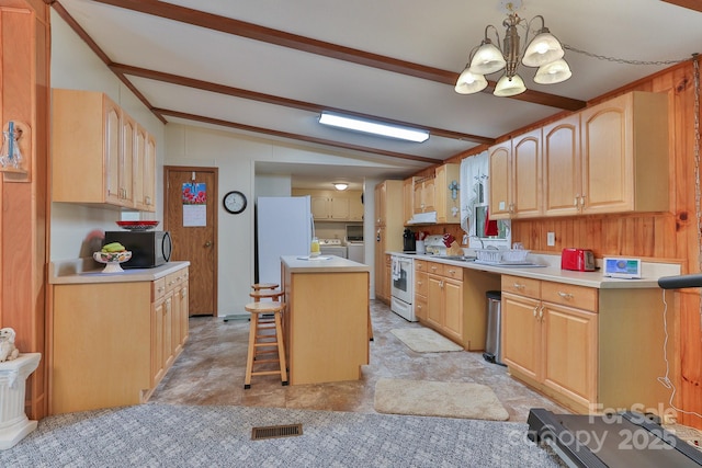 kitchen with lofted ceiling with beams, white appliances, washing machine and dryer, a center island, and a notable chandelier