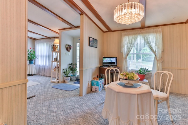 carpeted dining area featuring an inviting chandelier and ornamental molding