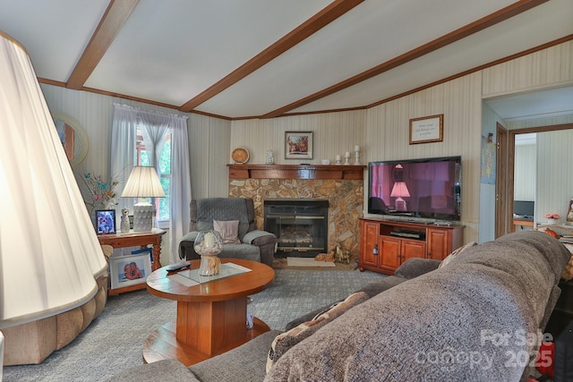 living area featuring lofted ceiling with beams, crown molding, a stone fireplace, and wood finished floors