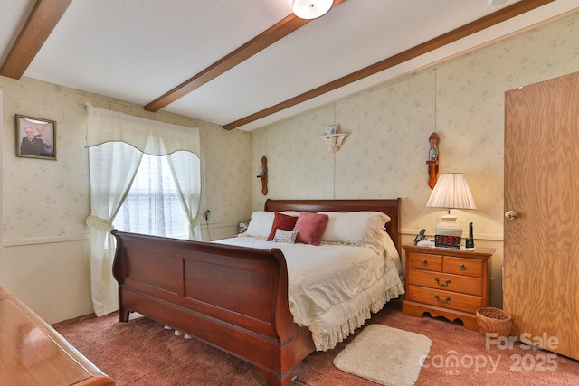 carpeted bedroom with beamed ceiling and wallpapered walls
